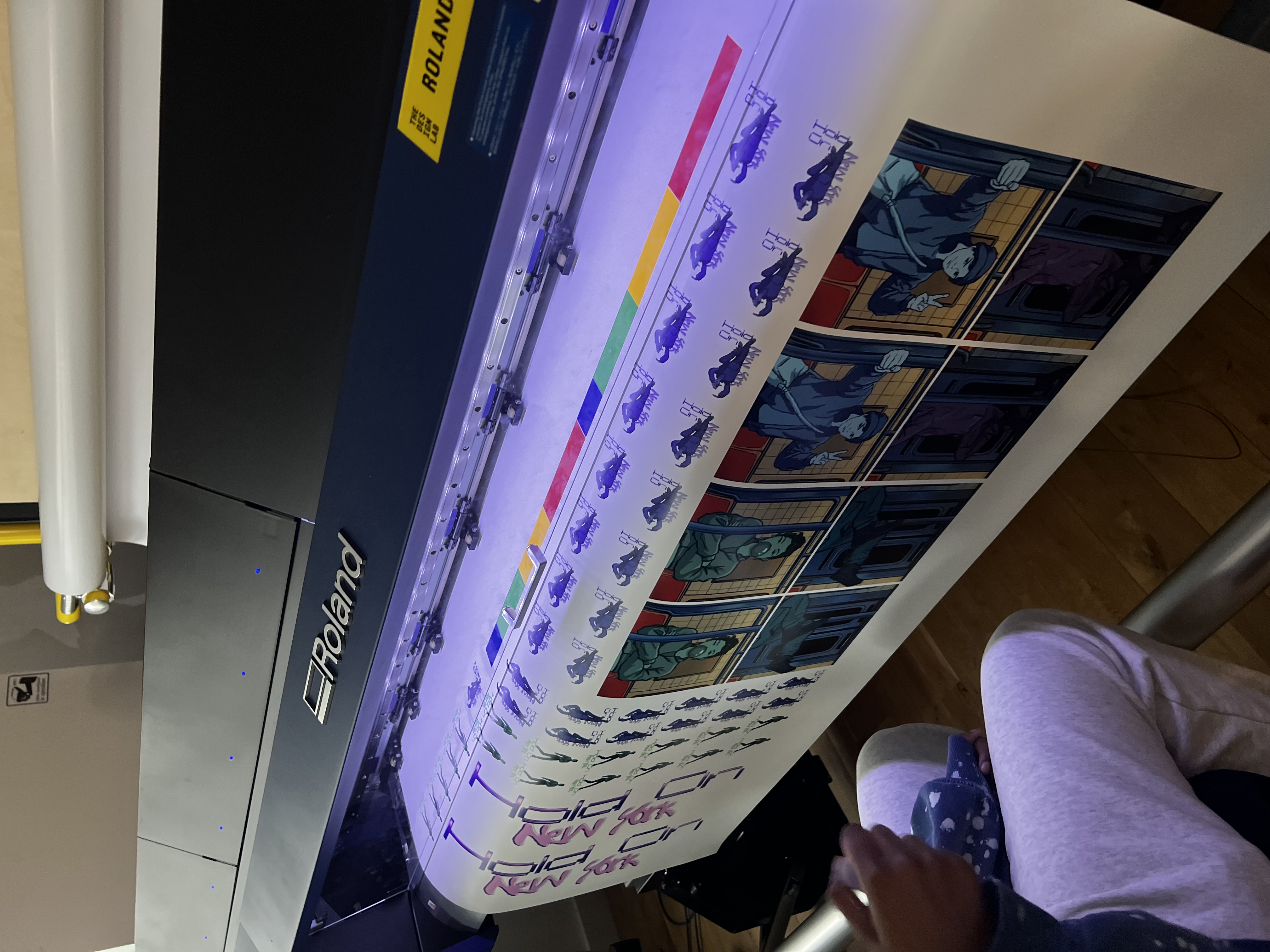 Roland printer printing vinyl stickers with Hold On New York character art